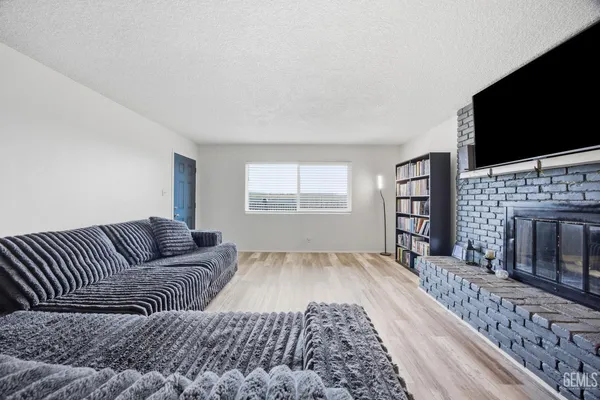 a living room with furniture fireplace and flat screen tv