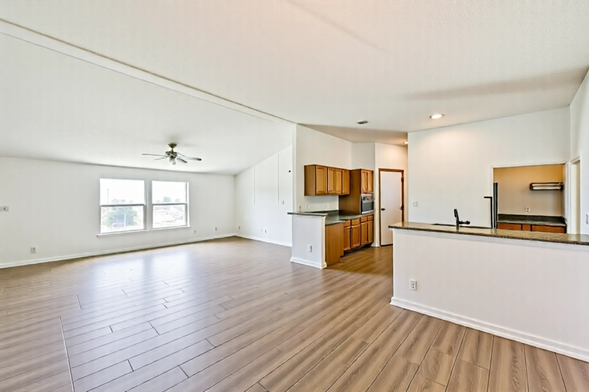 14515 Farm To Market Road 523 Angleton, TX 77515 - Photo 12 of 25 a view of a kitchen with wooden floor and electronic appliances