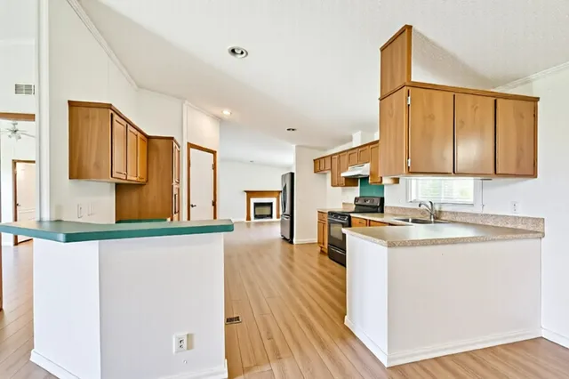 a kitchen with a sink a stove and cabinets