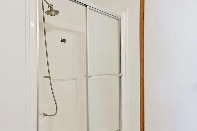 a bathroom with a glass shower door