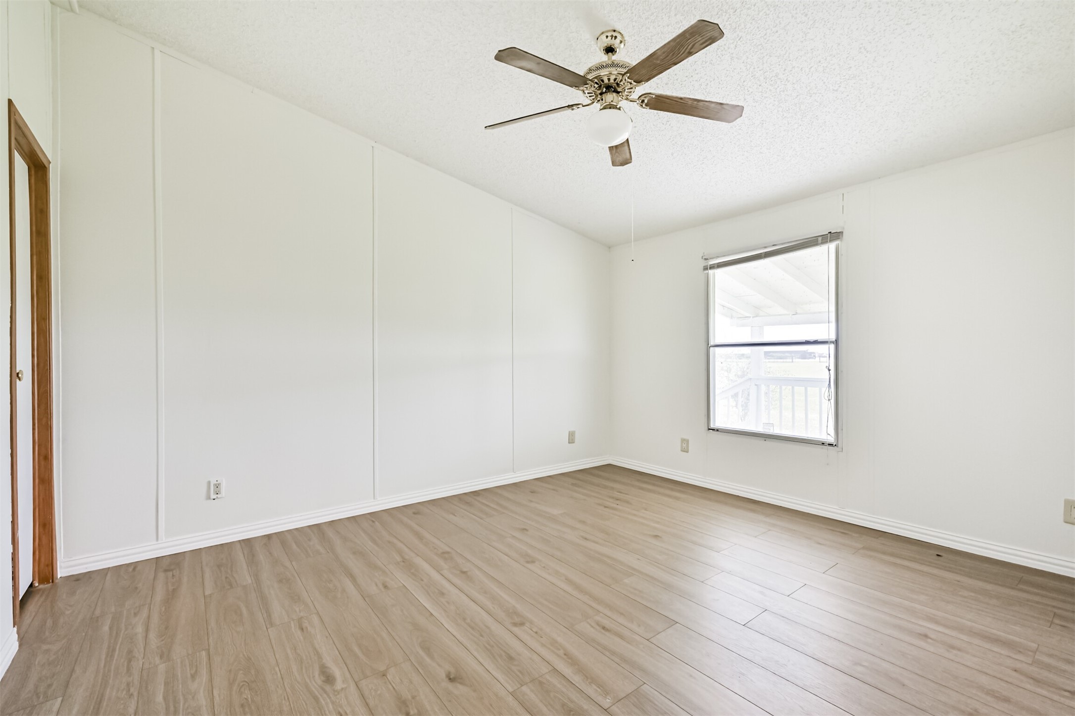 14515 Farm To Market Road 523 Angleton, TX 77515 - Photo 21 of 25 an empty room with wooden floor and windows