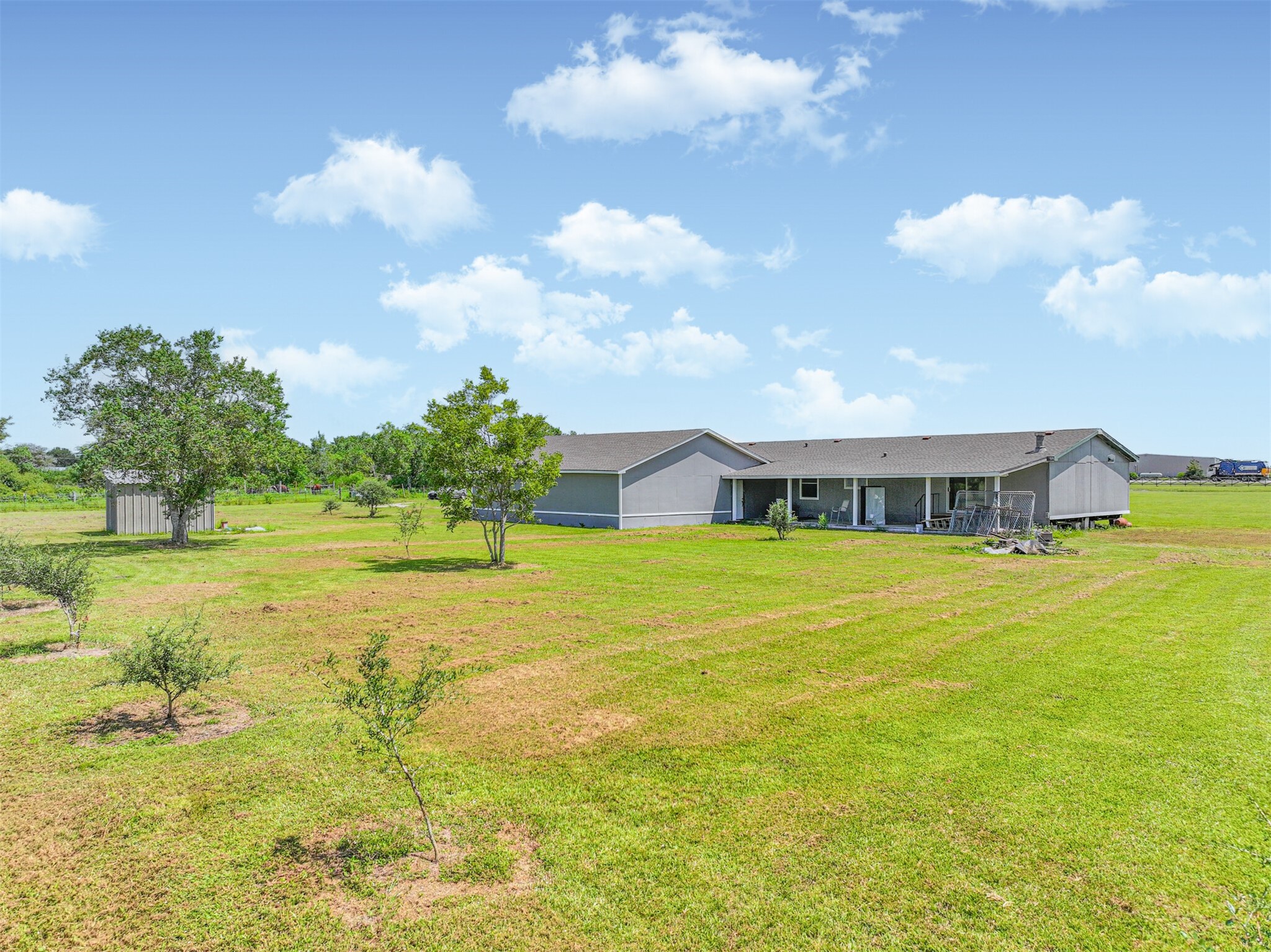 14515 Farm To Market Road 523 Angleton, TX 77515 - Photo 5 of 25 a swimming pool with lawn chairs