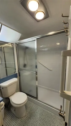 a bathroom with a toilet and a shower