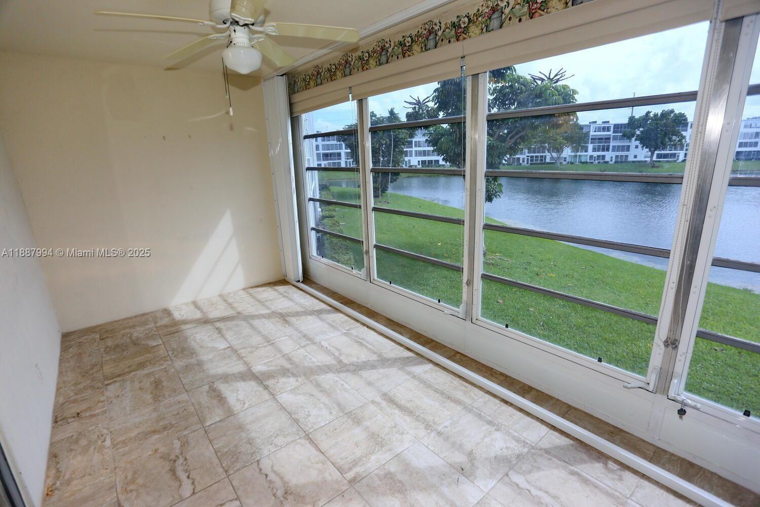 2079 Harwood F, Unit 2079 Deerfield Beach, FL 33442 - Photo 16 of 33 a view of empty room with wooden floor and fan