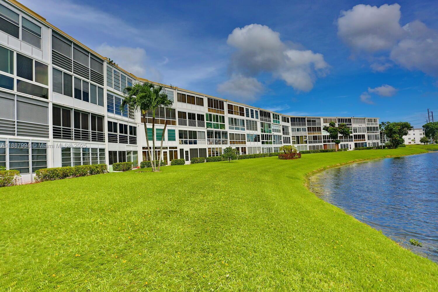 2079 Harwood F, Unit 2079 Deerfield Beach, FL 33442 - Photo 22 of 33 a view of a house with a yard and sitting area