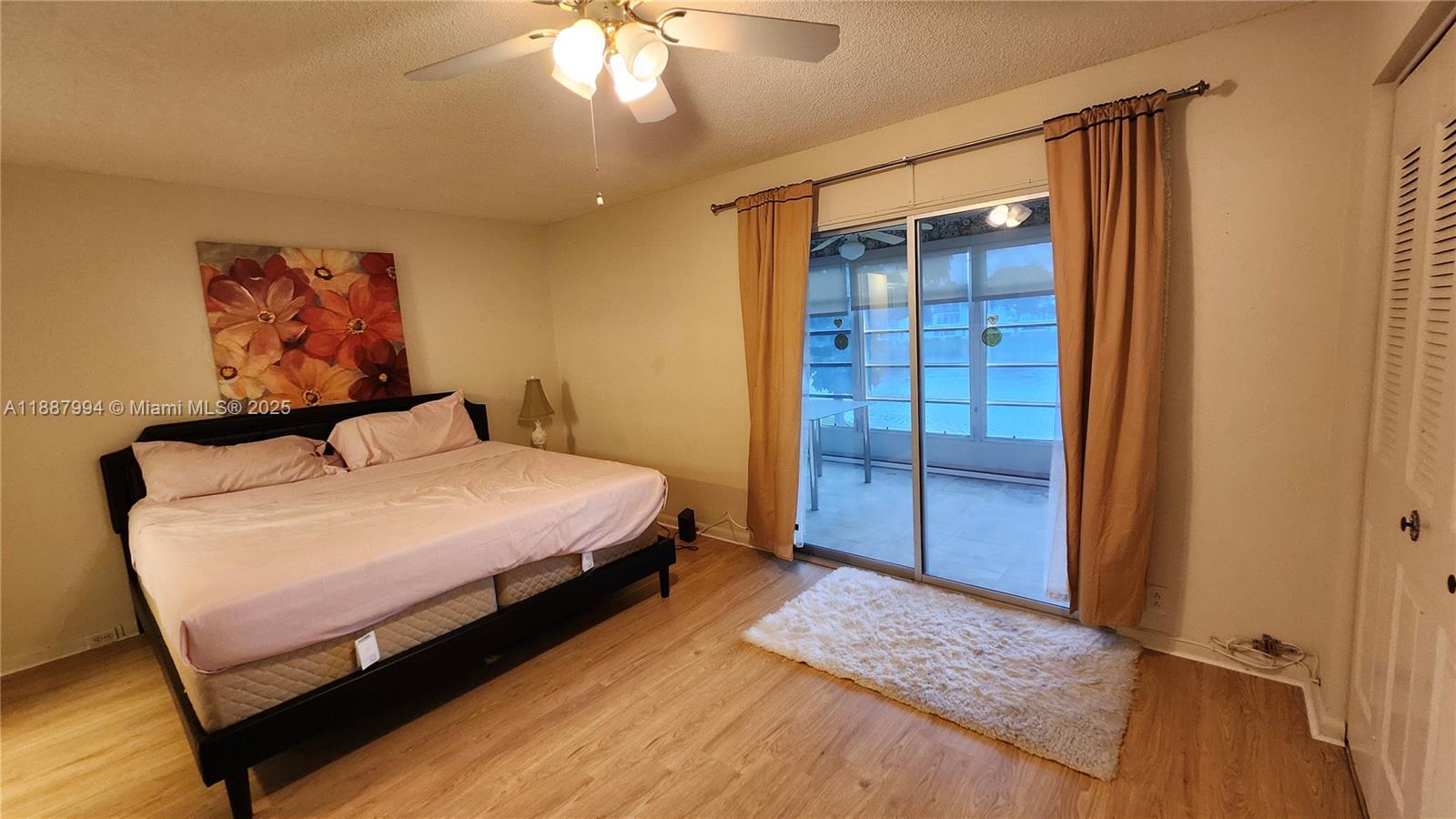 2079 Harwood F, Unit 2079 Deerfield Beach, FL 33442 - Photo 10 of 33 a bedroom with a bed and a mirror