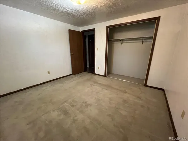 a view of an empty room with closet area