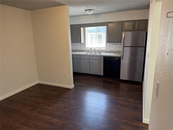 a kitchen with a refrigerator sink and cabinets