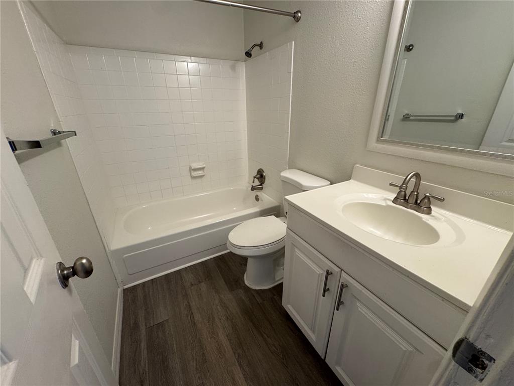 525 South Conway Road, Unit 220 Orlando, FL 32807 - Photo 9 of 12 a bathroom with a sink toilet tub and shower