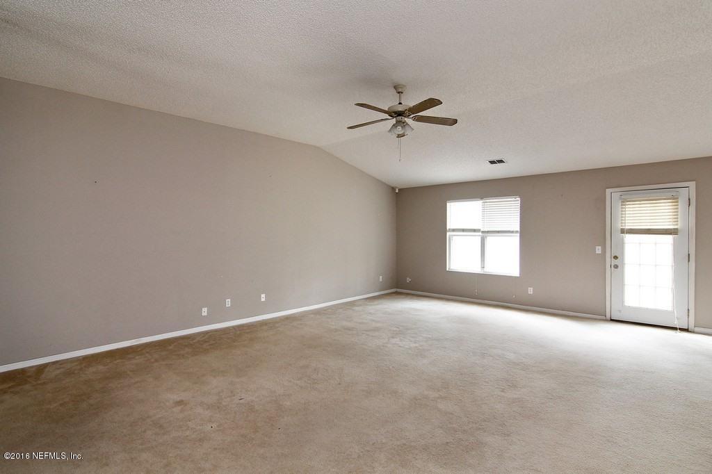 12842 Moose Road Jacksonville, FL 32226 - Photo 3 of 18 a view of an empty room with a window