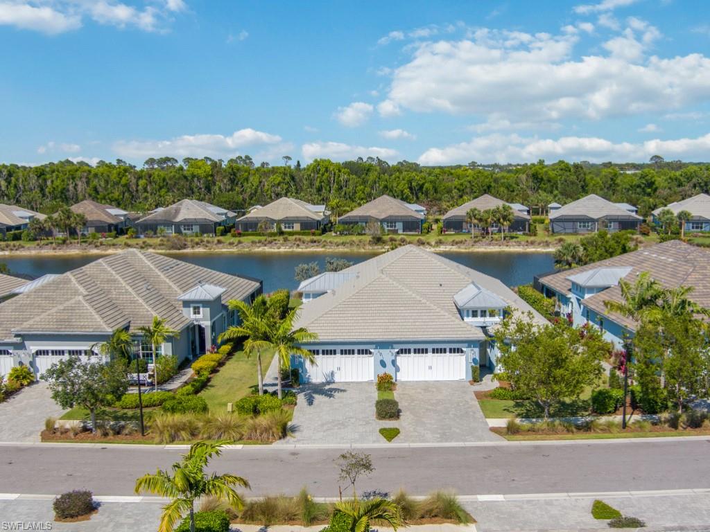 5697 Highbourne Drive Naples, FL 34113 - Photo 1 of 35 an aerial view of residential houses with outdoor space and river
