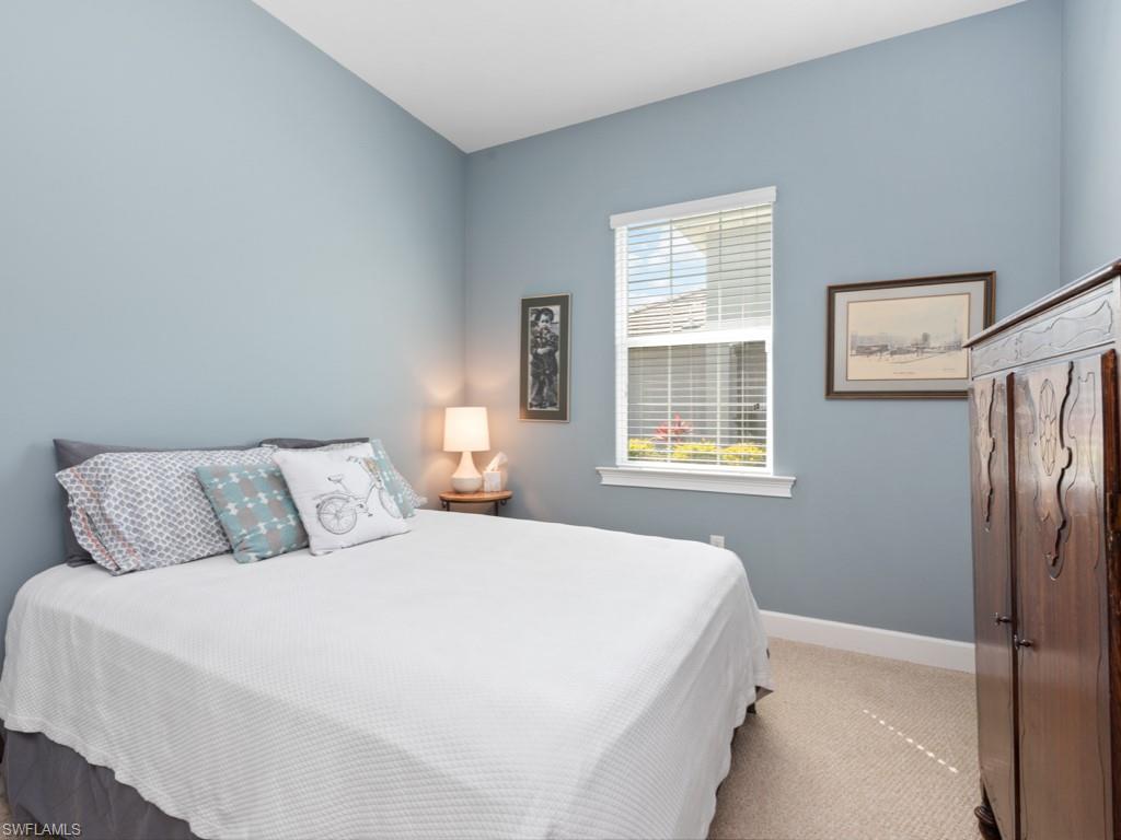 5697 Highbourne Drive Naples, FL 34113 - Photo 17 of 35 a bedroom with a bed and a window