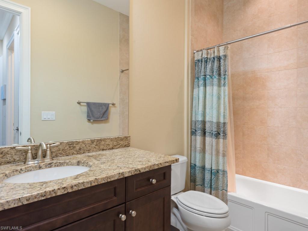 5697 Highbourne Drive Naples, FL 34113 - Photo 18 of 35 a bathroom with a granite countertop sink toilet and shower