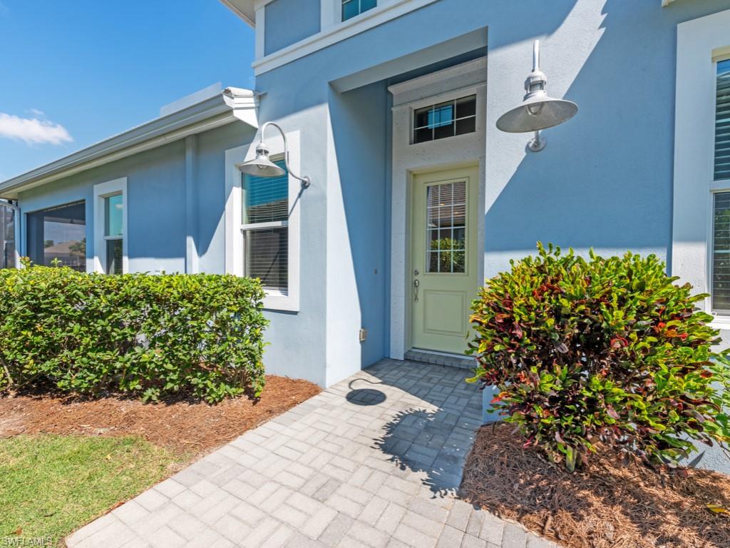 5697 Highbourne Drive Naples, FL 34113 - Photo 25 of 35 front view of a house with a yard
