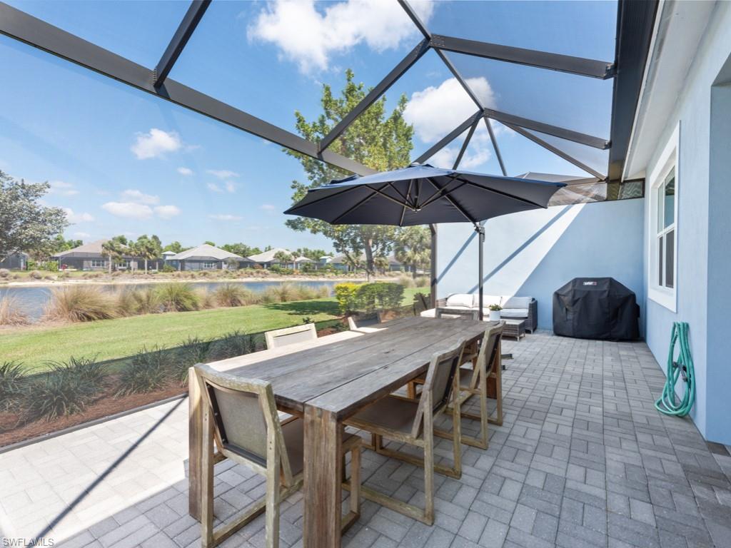 5697 Highbourne Drive Naples, FL 34113 - Photo 4 of 35 a view of deck with furniture and umbrella