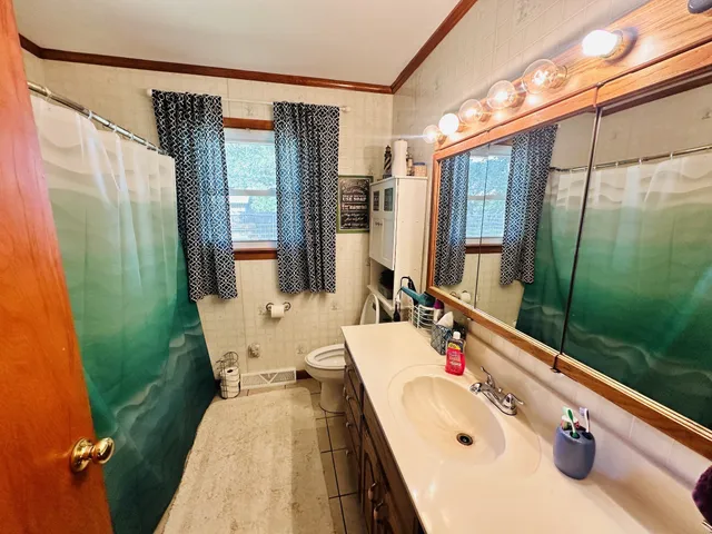 a bathroom with a tub sink and mirror