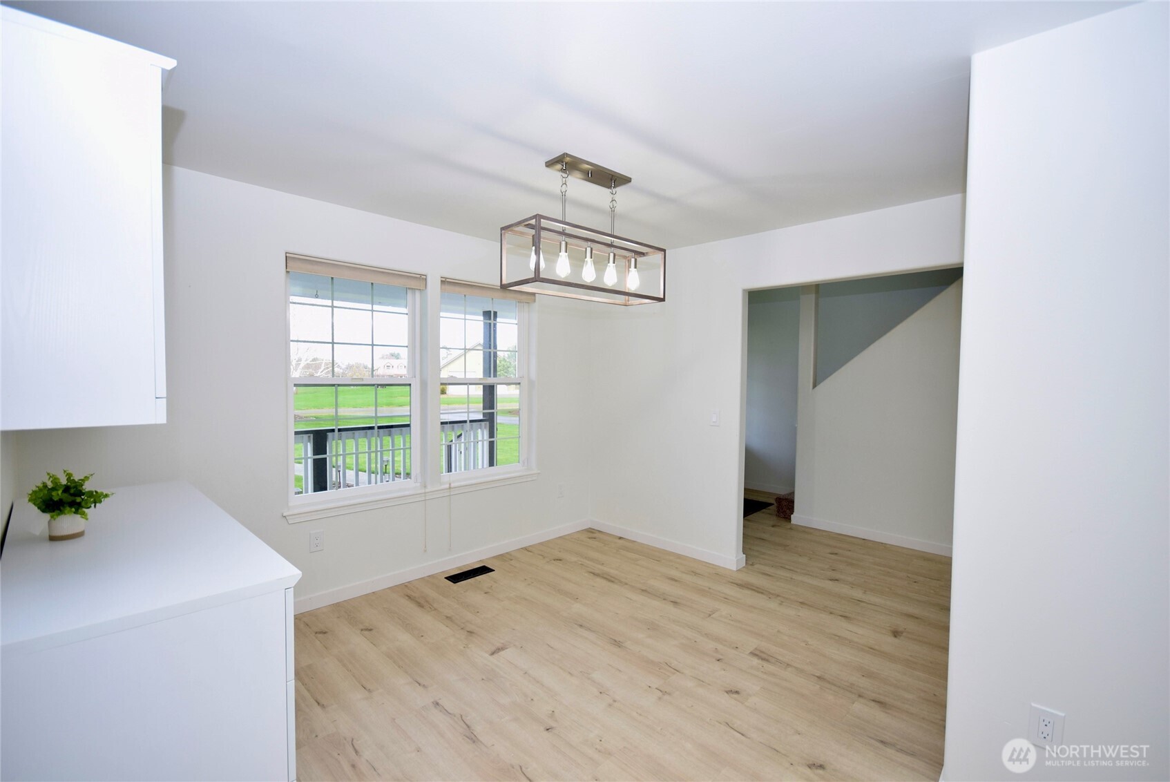 71 John Carl Road Sequim, WA 98382 - Photo 14 of 37 an empty room with wooden floor cabinet and windows