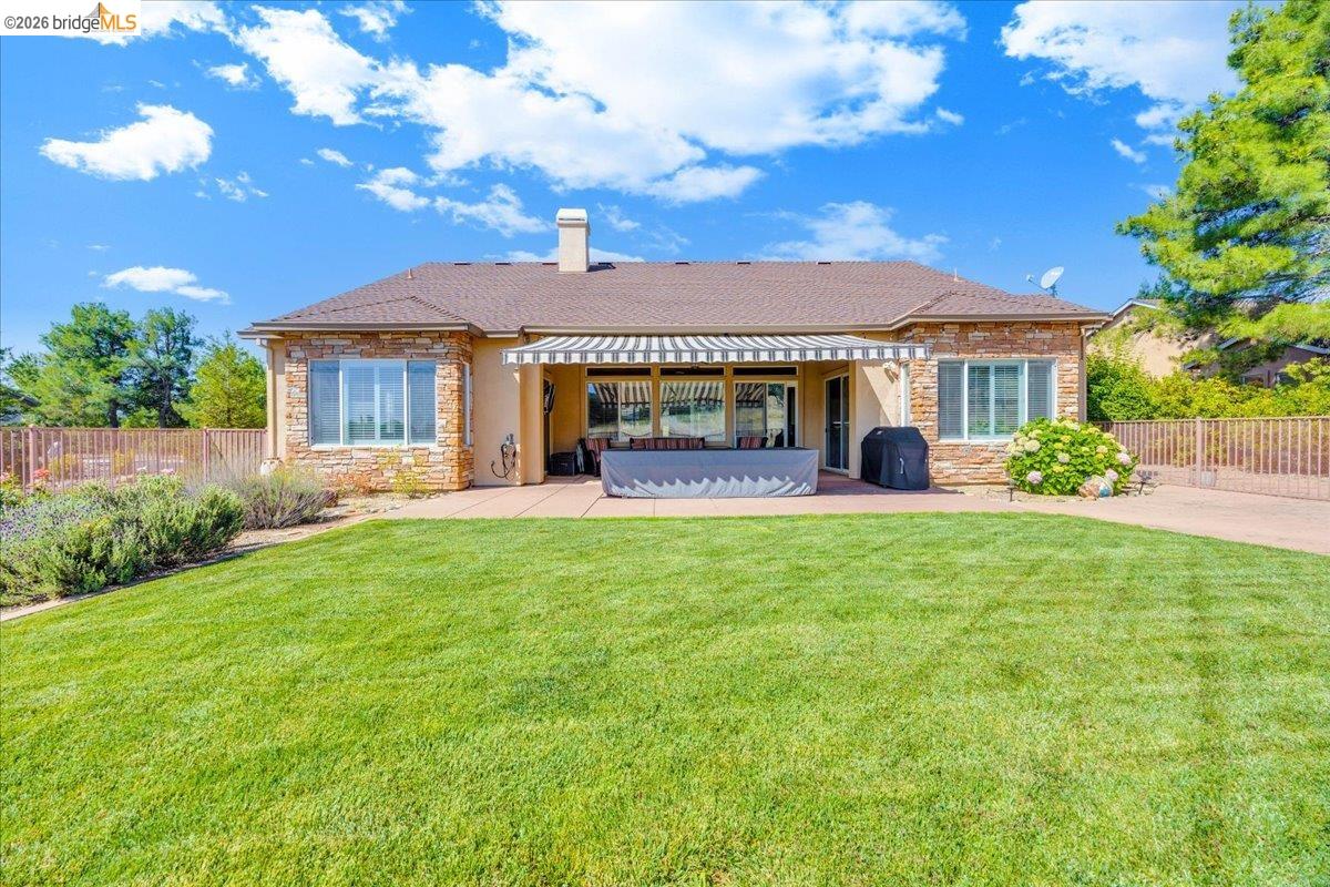158 Rock Ridge Lane Copperopolis, CA 95228 - Photo 49 of 72 Spacious backyard featuring a substantial lawn area, a paved patio, and mature landscaping