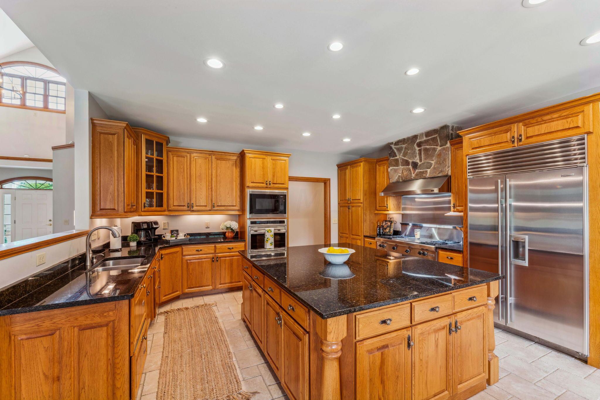 8242 Dustin Road Galena, OH 43021 - Photo 21 of 111 Custom Amish Hickory cabinetry, granite counters, SS Gourmet appliances (Wolf cooktop & Sub-serzo refrigerator) built in wall oven & microwave.
