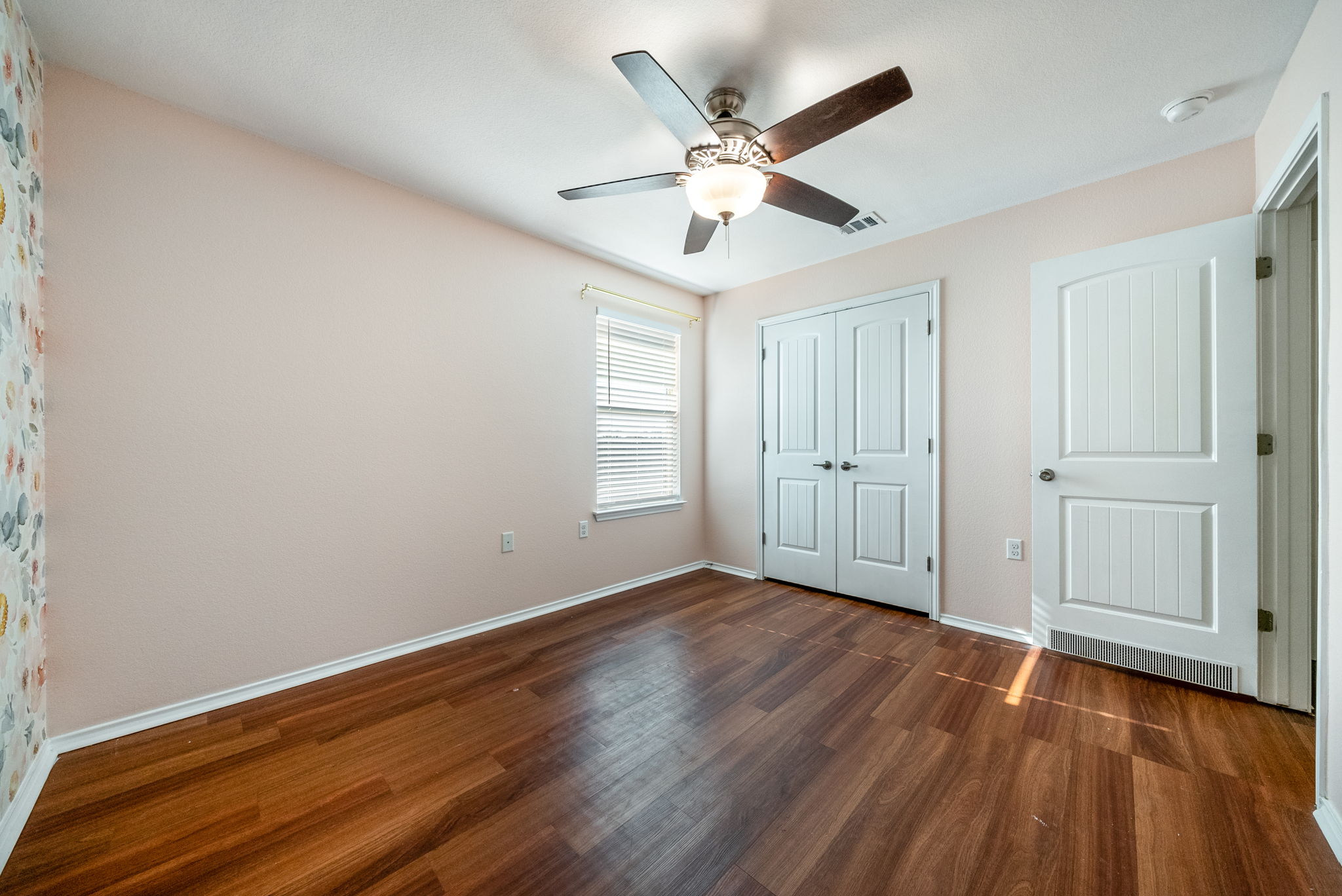 7124 Outfitter Drive Austin, TX 78744 - Photo 16 of 25 an empty room with wooden floor and windows