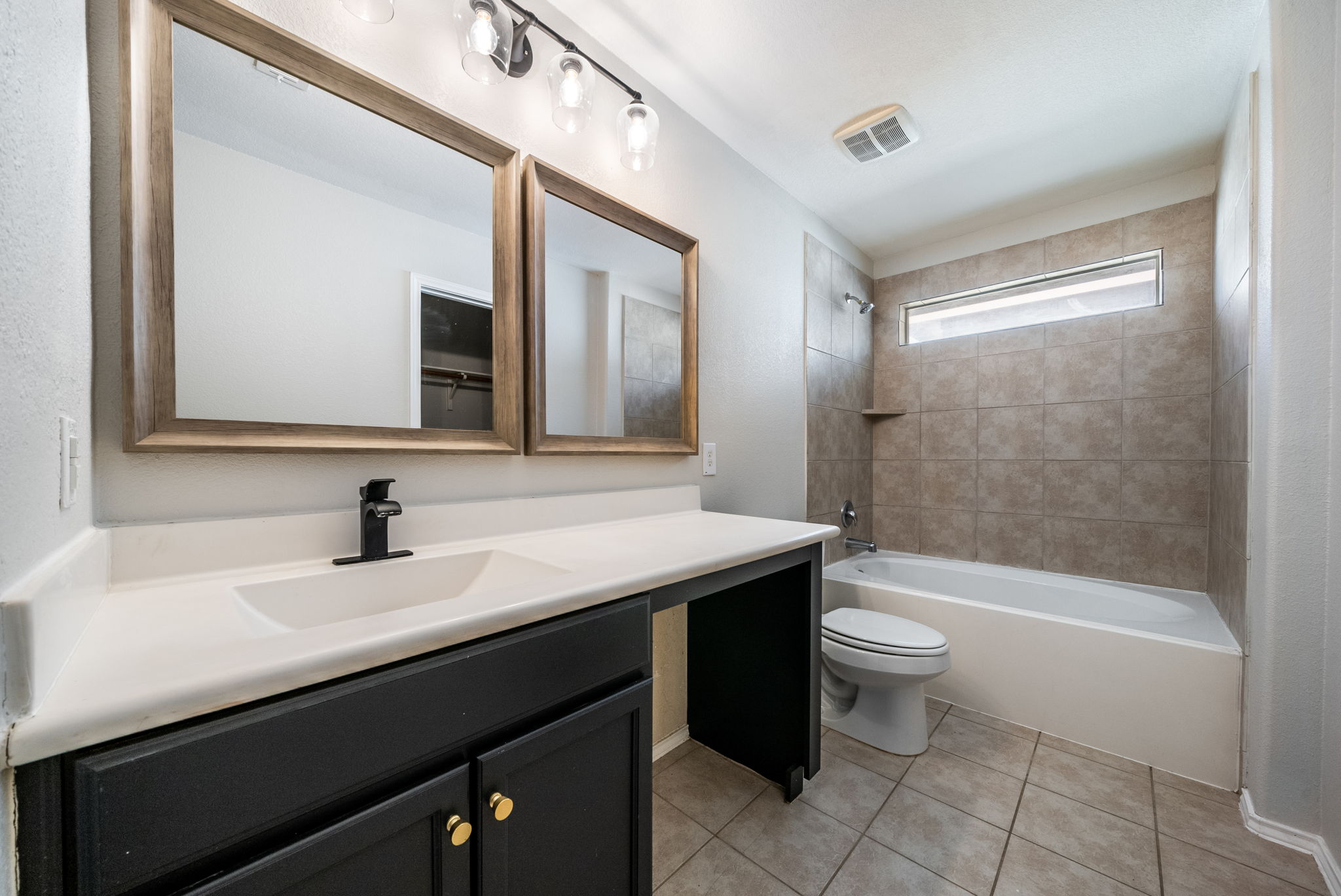 7124 Outfitter Drive Austin, TX 78744 - Photo 20 of 25 a bathroom with a sink a toilet and shower