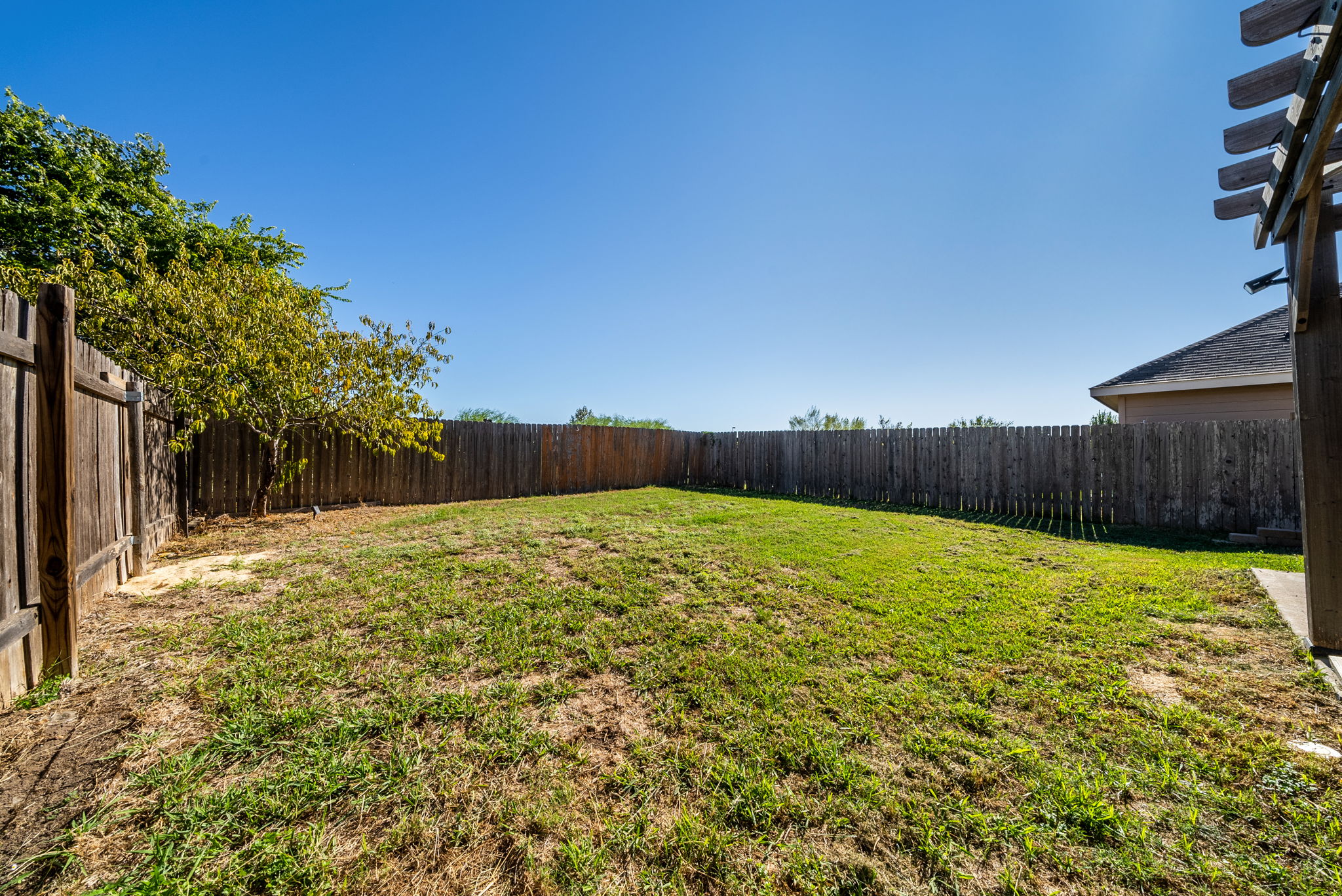 7124 Outfitter Drive Austin, TX 78744 - Photo 24 of 25 a view of a yard with wooden fence