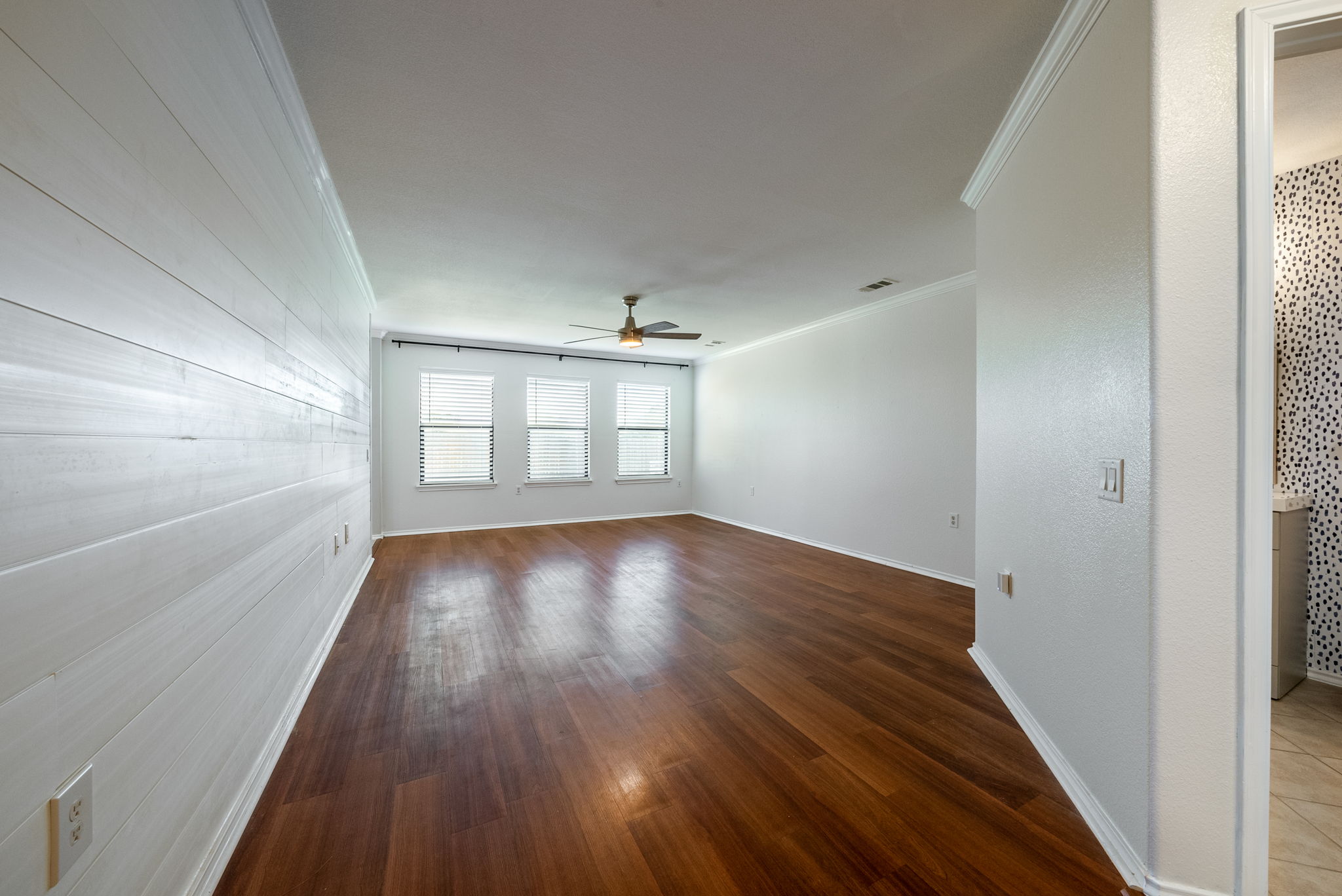 7124 Outfitter Drive Austin, TX 78744 - Photo 4 of 25 wooden floor in an empty room with a window