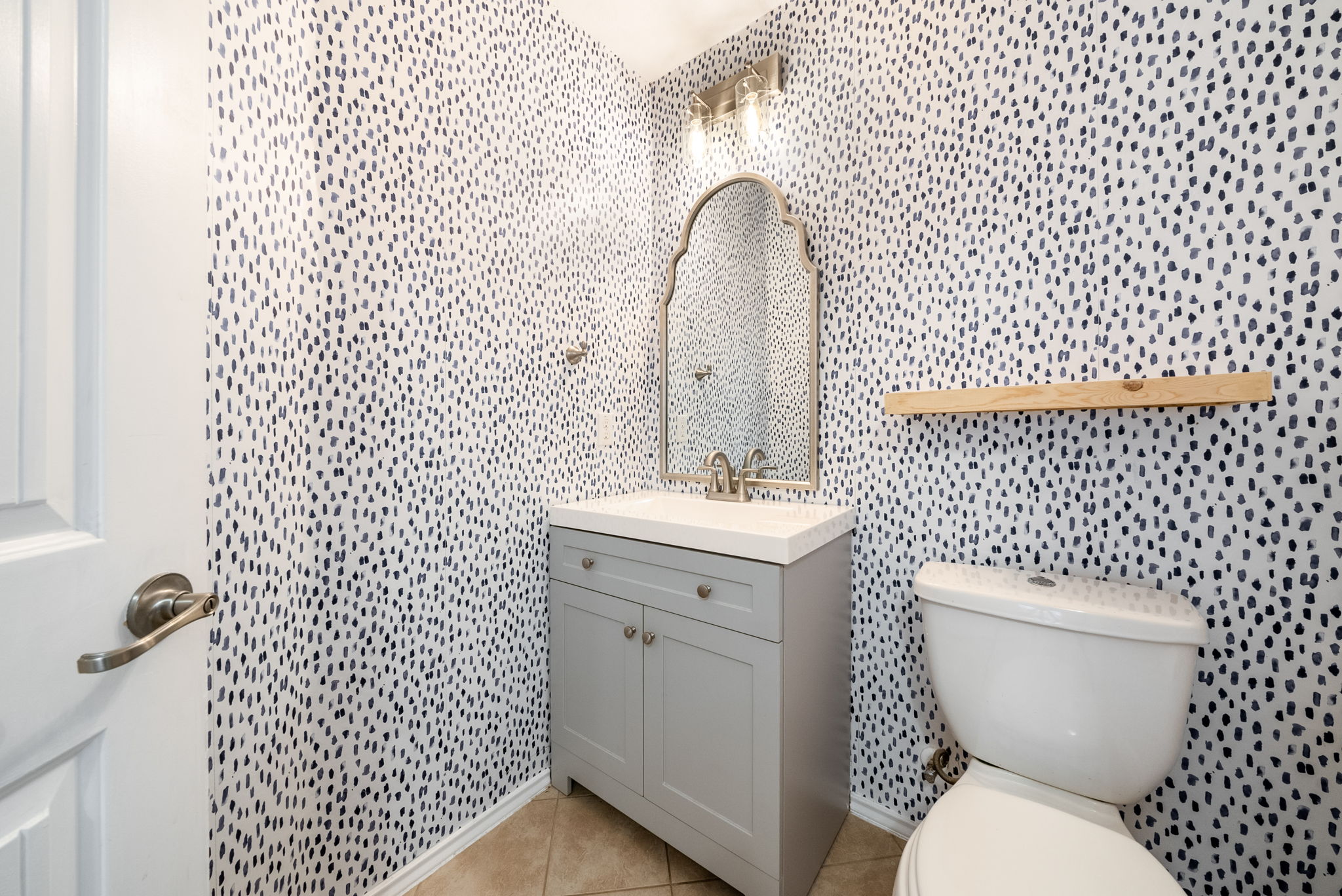 7124 Outfitter Drive Austin, TX 78744 - Photo 5 of 25 a bathroom with a toilet a sink and mirror