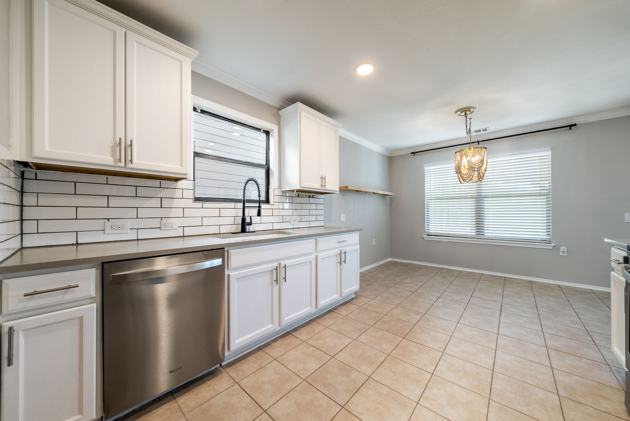 7124 Outfitter Drive Austin, TX 78744 - Photo 9 of 25 a kitchen with stainless steel appliances granite countertop a sink stove and cabinets