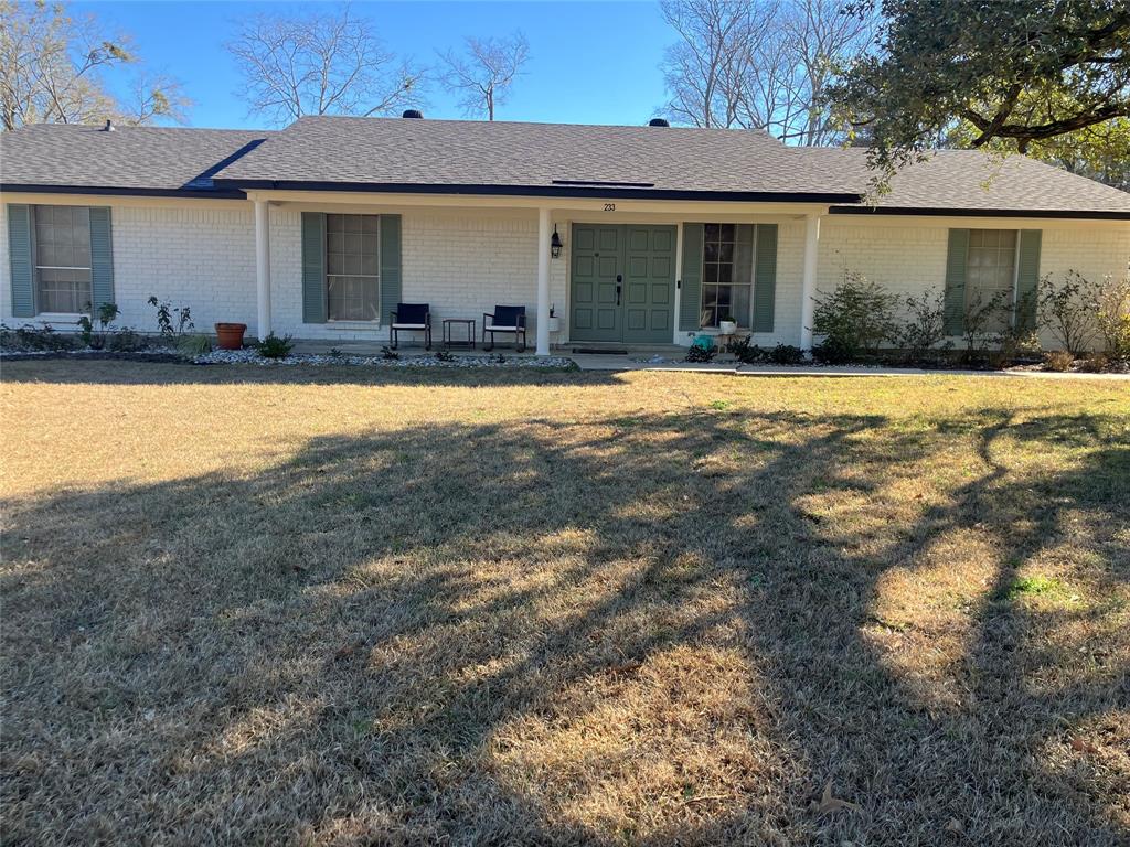 233 Church Road Stonewall, LA 71078 - Photo 1 of 32 Ranch-style house featuring covered porch, a shingled roof, brick siding, and a front lawn