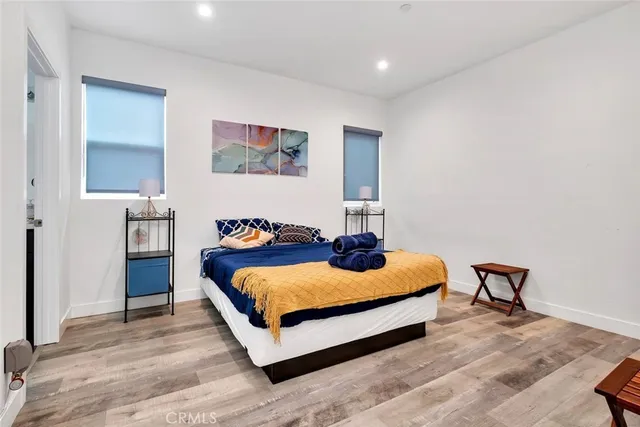 a bed room with bed and a chair