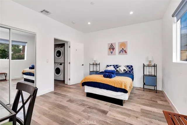 a bedroom with a bed and painting on the wall