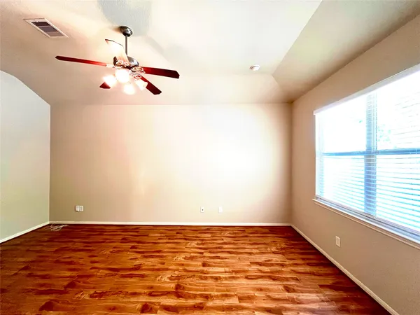 an empty room with wooden floor and sliding door