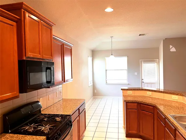 a kitchen with a sink refrigerator and cabinets