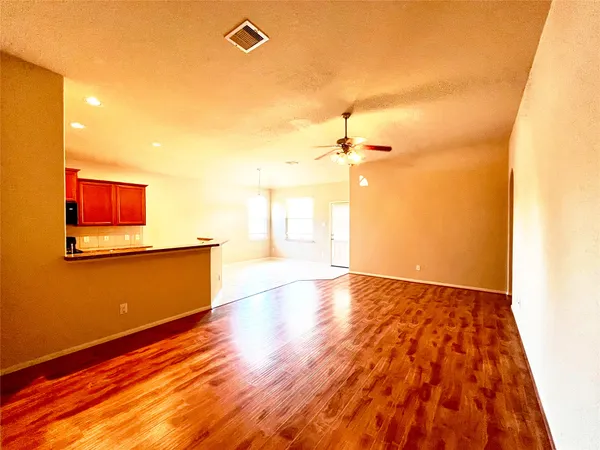 a large kitchen with granite countertop a sink and cabinets