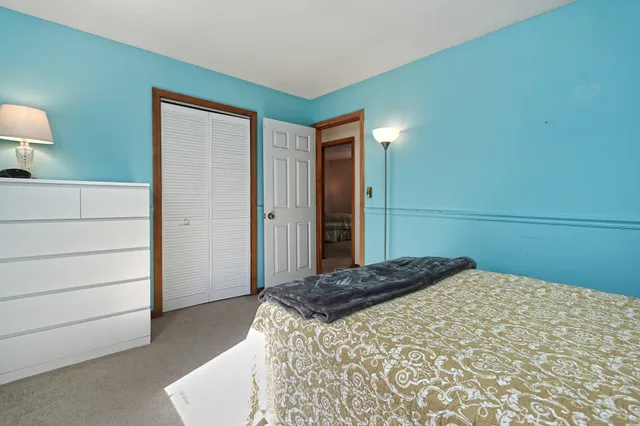 a bedroom with a bed and a mirror