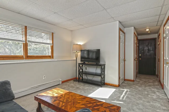 a bedroom with a bed and a television