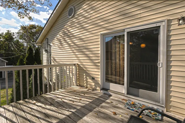 a view of a balcony with wooden floor
