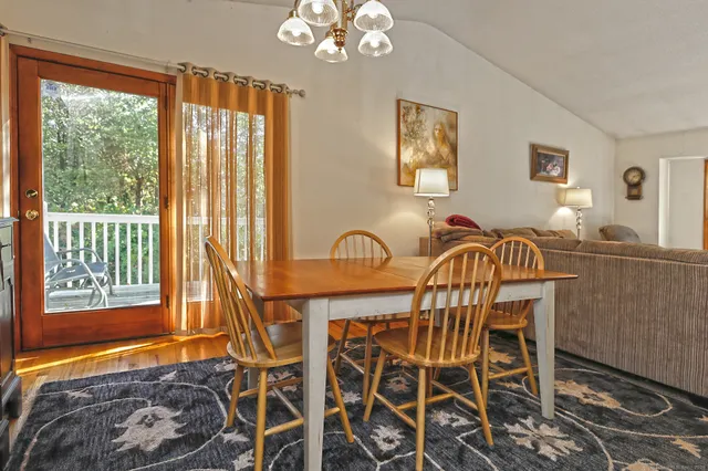 a view of a dining room with furniture and chandelier
