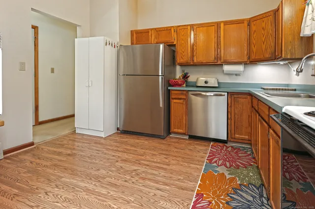 a kitchen with a refrigerator sink and cabinets