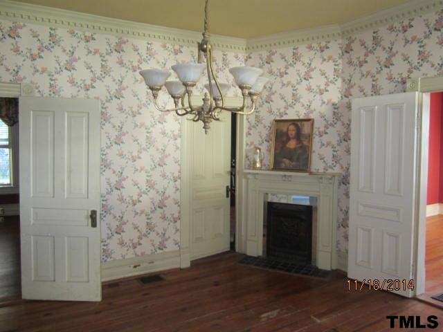 416 South Main Street Roxboro, NC 27573 - Photo 3 of 18 a view of a livingroom with wooden floor and a fireplace