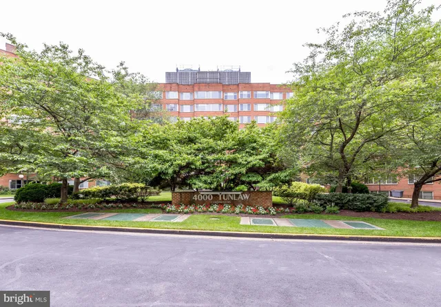 a front view of a building with a garden