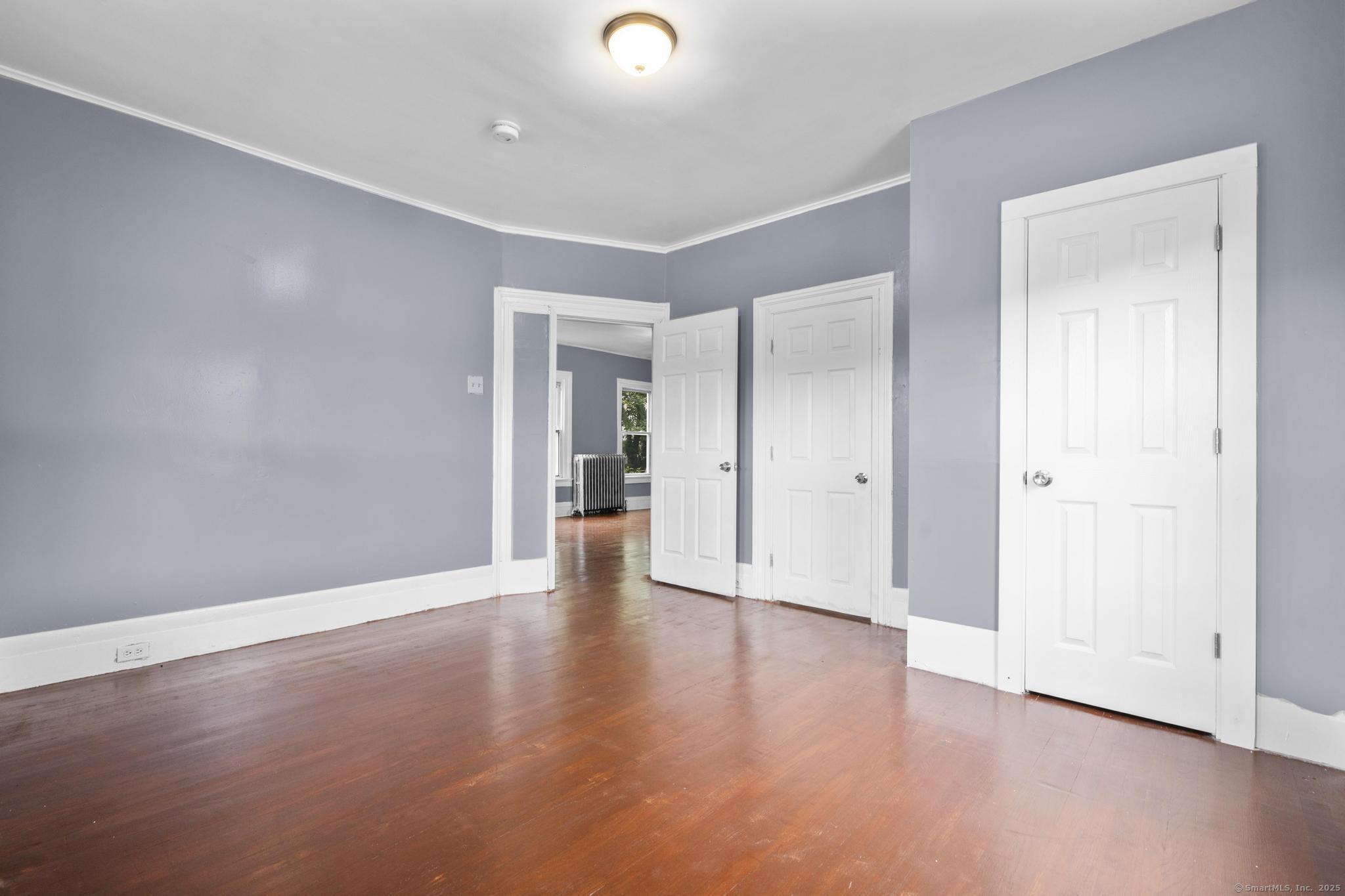 1105 North Main Street, Unit 1 Waterbury, CT 06704 - Photo 20 of 37 a view of an empty room with wooden floor