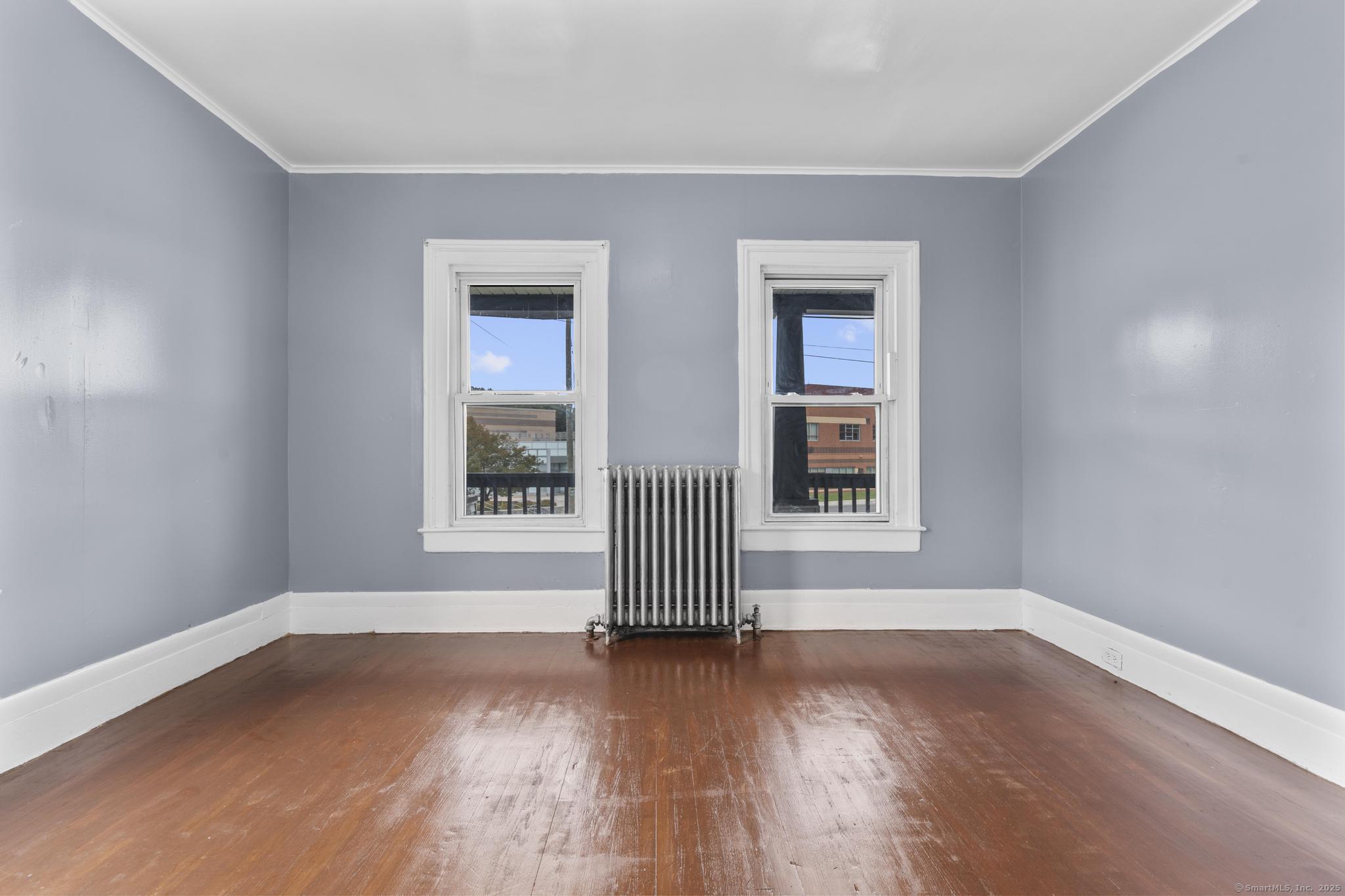 1105 North Main Street, Unit 1 Waterbury, CT 06704 - Photo 21 of 37 a view of empty room with wooden floor and fan