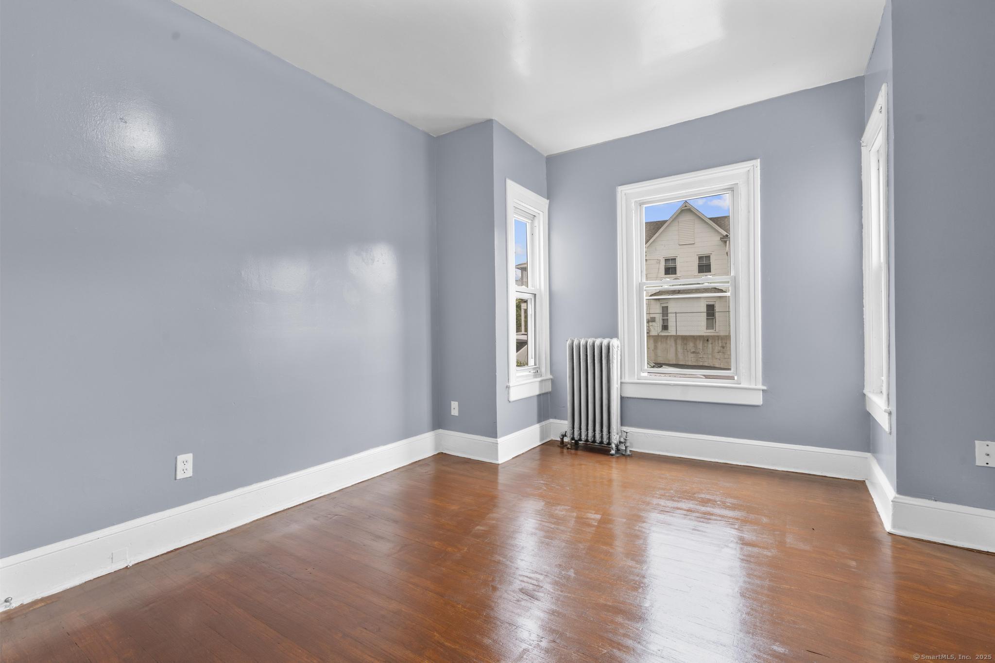1105 North Main Street, Unit 1 Waterbury, CT 06704 - Photo 22 of 37 a view of livingroom with window wooden floor and window