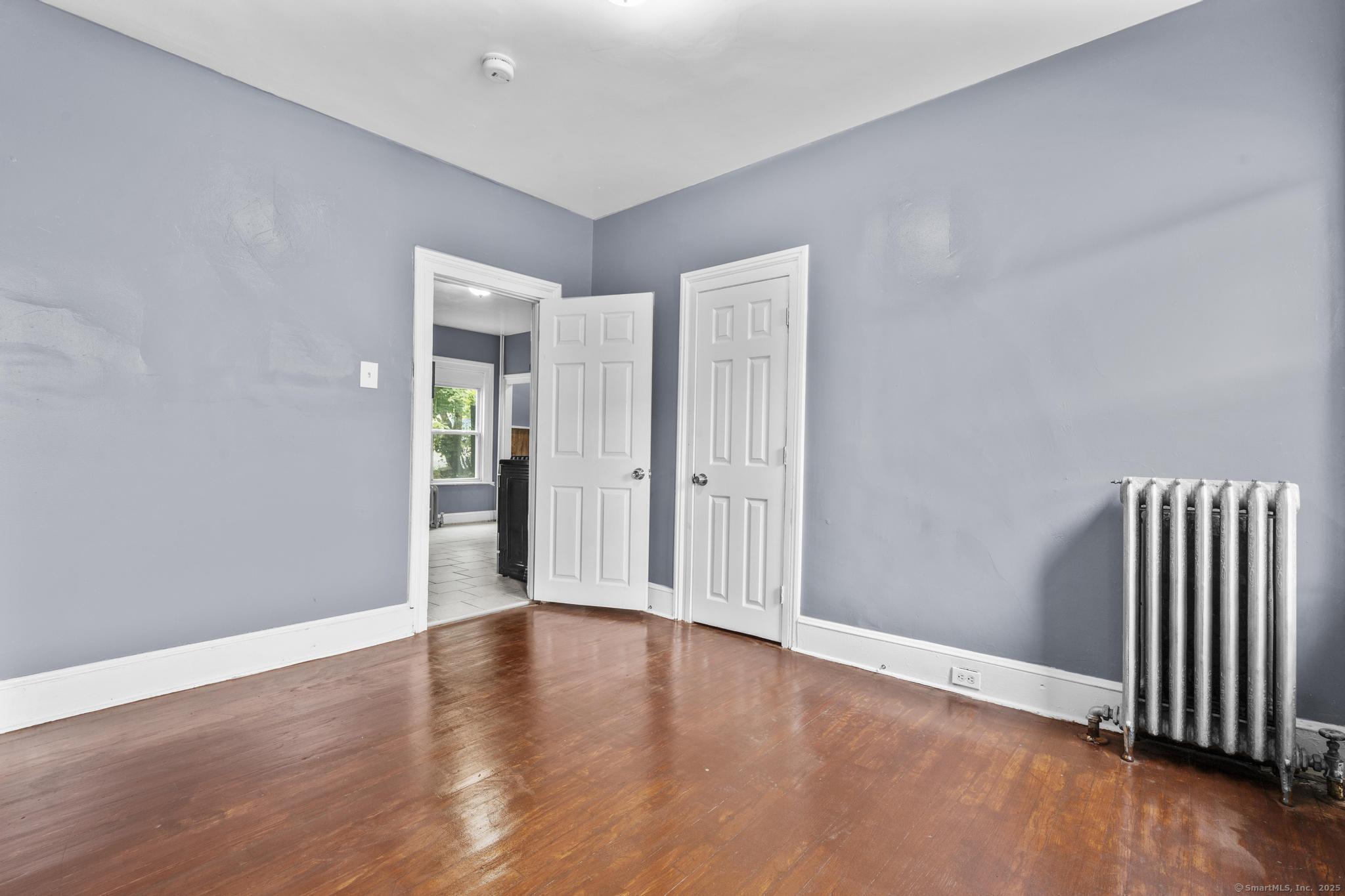1105 North Main Street, Unit 1 Waterbury, CT 06704 - Photo 26 of 37 a view of an empty room with wooden floor