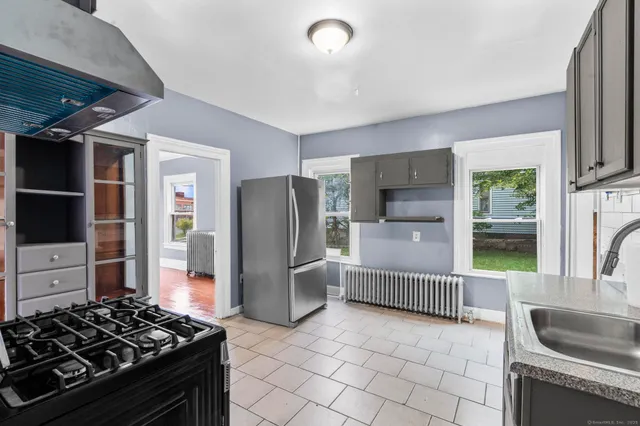 a kitchen with stainless steel appliances granite countertop a refrigerator and a sink