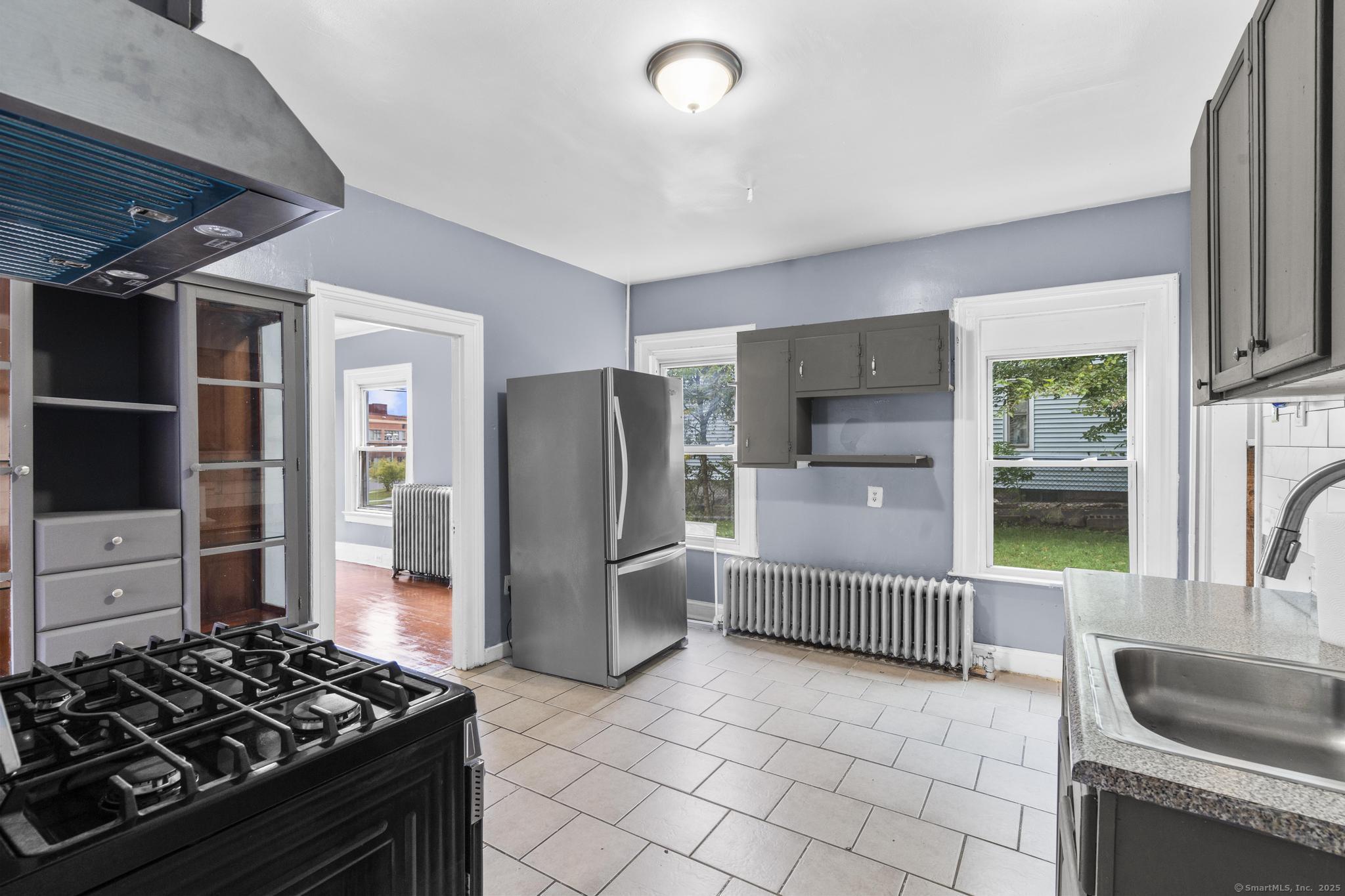1105 North Main Street, Unit 1 Waterbury, CT 06704 - Photo 31 of 37 a kitchen with stainless steel appliances granite countertop a refrigerator and a sink