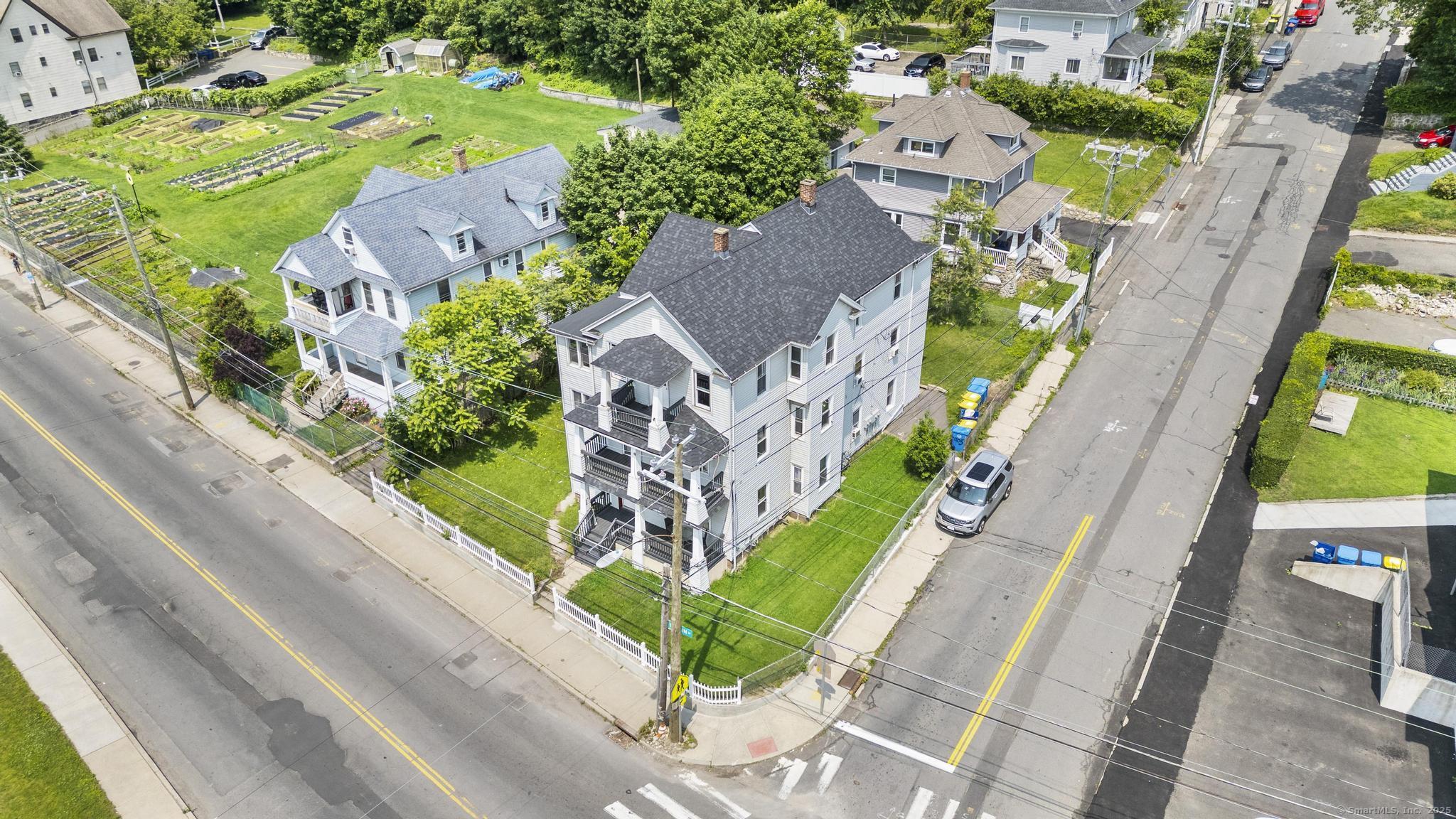 1105 North Main Street, Unit 1 Waterbury, CT 06704 - Photo 4 of 37 an aerial view of a house with a garden and plants