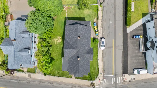 an aerial view of a residential apartment building with a yard and potted plants